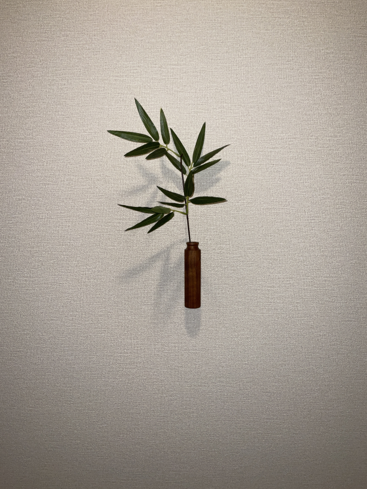 A wooden single flower vase